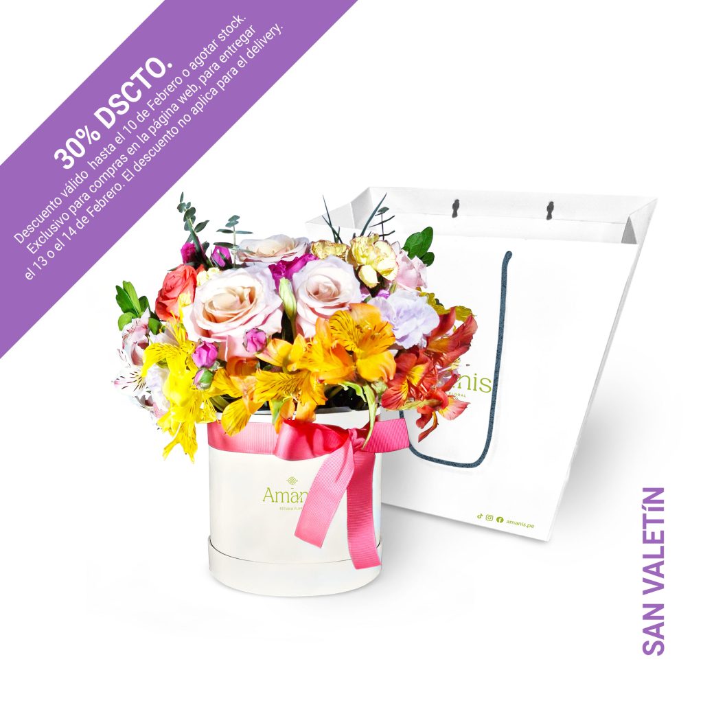 Un delicado arreglo con 8 rosas en tonos suaves entre coral, rosa y morado, acompañado de gerberas, minirosas, claveles y lisianthus en tonalidades pastel que acompañan y follaje variado. Presentado en un elegante box cilíndrico de 15x15 cm, con altura final variable dependiendo del tipo de arreglo. Incluye tarjeta de cuidados y dedicatoria personalizada.
